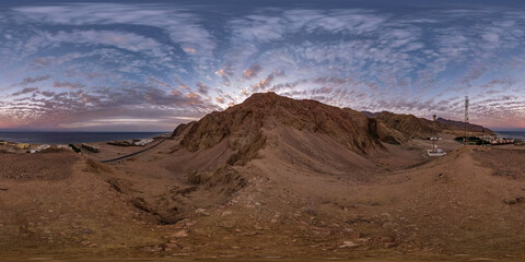 full seamless spherical hdri 360 panorama view of sunset on coast of sea high in sandy mountains...