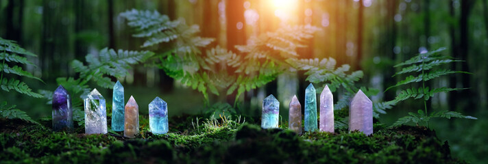 quartz Gemstones on mysterious forest natural background. minerals for esoteric Magic crystal Ritual, Witchcraft, spiritual practice. reiki healing therapy for life balance, soul relax. banner