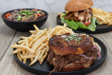 Table feast of a variety of bar food choices with the braised short rib grilled cheese sandwich featured here