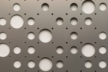 Round hole tiles. Metal cladding of the building facade