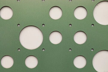 Round hole tiles. Metal cladding of the building facade