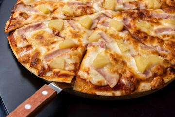 Slice of hot pizza large cheese lunch or dinner crust seafood meat topping sauce. with bell pepper vegetables delicious tasty fast food italian traditional on wooden board table classic in side view .