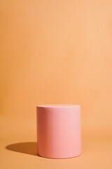 product platform arrangement in pink pastel color in minimalist style. trendy display layout with an empty podium for showcasing cosmetics, skincare, or other products.                               