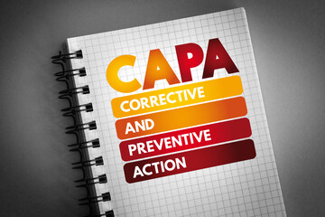 CAPA - Corrective and preventive action acronym on notepad, business concept background