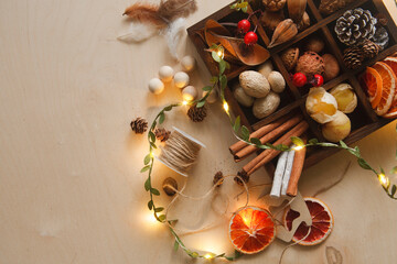 Handmade Christmas tree toys made of natural materials, dry oranges, cones, nuts, berries, New Year and Christmas decor concept of eco friendly plastic free materials, flat lay, copy space