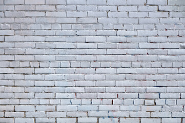 Brick wall painted with white paint