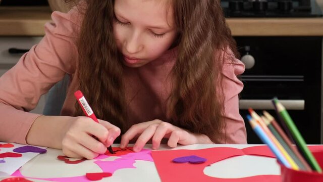 Valentines Day. Kids Crafts Paper Heart, tracing and cutting out hearts from pink paper for valentines day. Children crafts during homeschool preschool and kindergarten art class. Painting, DIY.