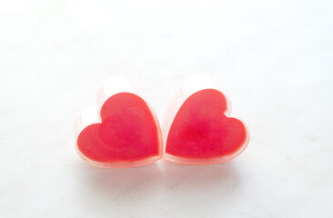 Fototapeta premium Two Valentine romantic hearts on white surface.