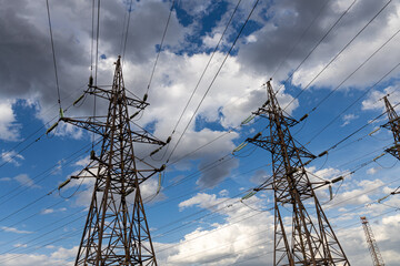 Rusty power line is on the blue sky with white clouds background