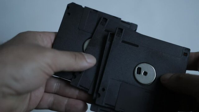 Man hold a 1.44Mb disk from the early 90s, mostly useless today