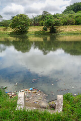 Fototapeta na wymiar Sewage and trash on water of city river. Pollution concept, ecosystem and environmental