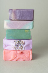 Stack of natural handmade soap on green background. Soap with different smells