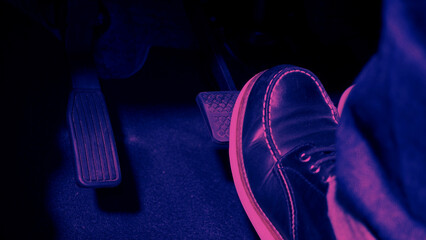 Accelerator and breaking pedal in a car. Close up the foot pressing foot pedal of a car to drive...