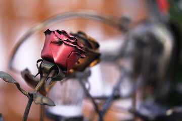 A beautiful rose made of metal on a blurry background. Selective focus. Copy space.