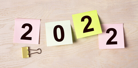 2022 year on sticky notes, colorful office papers.