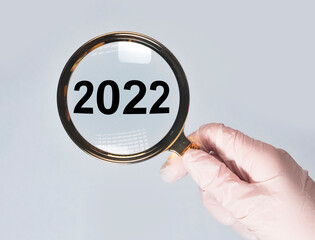 2022 new year, medical concept in hands over background.