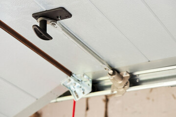 Automatic Garage Door mechanism close up. Lifting gates of the garage. Metal wheel, Springs...
