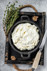Cream cheese Mascarpone in a wooden tray for tiramisu. White background. Top view