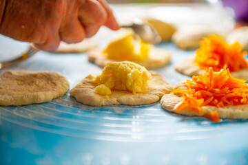 mom makes pies with carrots out of dough. High quality photo