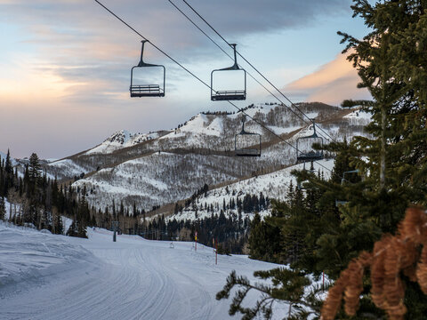 ski lift in the mountains at sunset