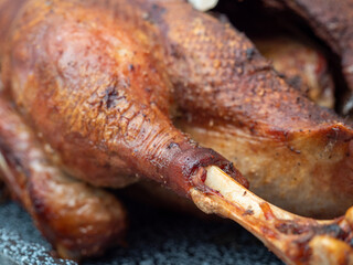 Close up of roast goose with blurred background.