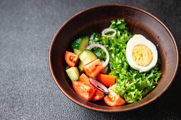 spring egg salad fresh vegetables, cucumber, tomato, lettuce healthy meal food snack on the table copy space food background rustic top view keto or paleo diet veggie vegan or vegetarian food