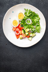spring egg salad fresh vegetables, cucumber, tomato, lettuce healthy meal food snack on the table copy space food background rustic top view keto or paleo diet veggie vegan or vegetarian food
