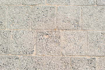 Texture of the paved tile on the bottom of the street. Cement brick squared stone floor background. Concrete paving slabs. Paving slabs
