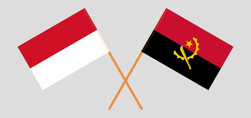 Crossed flags of Indonesia and Angola. Official colors. Correct proportion