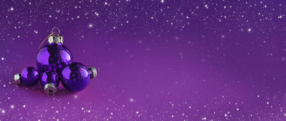 Obraz na płótnie Canvas Bright purple Christmas balls on purple background. Merry Christmas and happy New Year