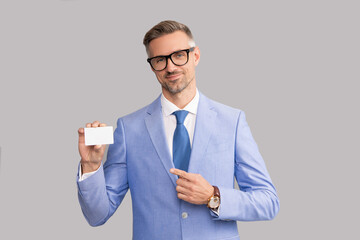smiling mature man in glasses pointing finger on credit card and thumb up, copy space, call me