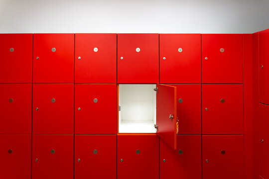 Deposit red locker boxes or gym lockers inside of a room with one central opened door