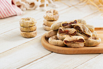 Cut and whole dried figs placed on white wooden table. Hight quality
