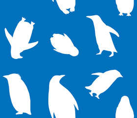 Vector seamless pattern of hand drawn penguins silhouette isolated on blue background