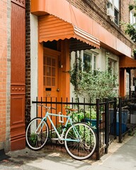 Bike and house with orange door in Greenpoint, Brooklyn, New York City