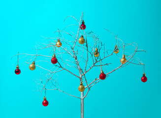Christmas unique and surreal still composition. Christmas baubles on silver tree. Creative layout...