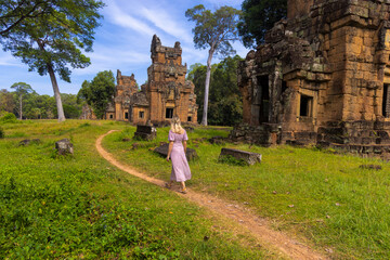 A western tourist in the ancient buildings in Angkor Thom, Cambodia