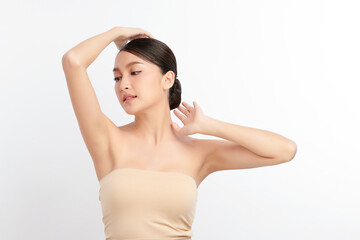 Fototapeta premium Beautiful Young Asian woman lifting hands up to show off clean and hygienic armpits or underarms on white background, Smooth armpit cleanliness and protection concept
