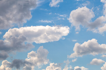 Naklejka na ściany i meble Blue sky with fluffy clouds on a sunny day