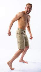 Obraz premium a muscular man in shorts holds a syringe and injects himself into the buttock and yells. anabolics, doping, medicine. White background