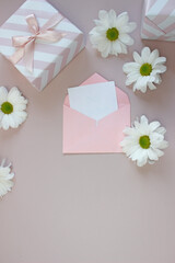 white paper blank and beautiful flower. top view for wedding mockup or greeting card on mother day in flat lay style.