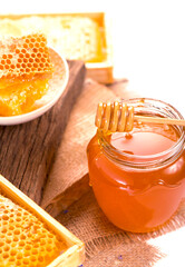 glass pot with floral honey isolated on white background