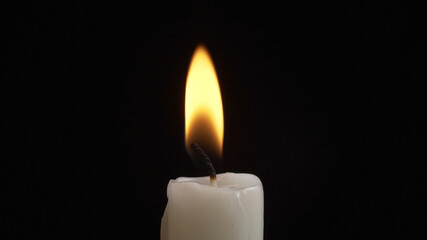 Shooting of burning candle on dark background