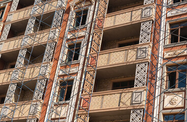 Finishing works on the facade of a new residential buildings