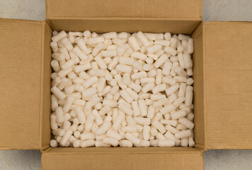 Empty cardboard box with styrofoam filler for safe packaging. Top view