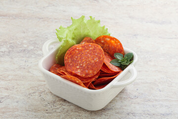 Sliced pepperoni sausage in the bowl