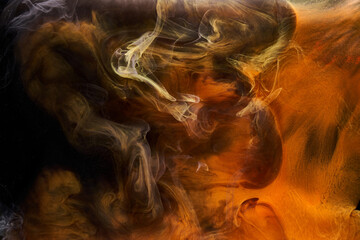 Orange smoke on black ink background, colorful fog, abstract swirling ocean sea, acrylic paint pigment underwater © amixstudio