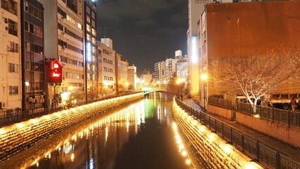 Fototapeta na wymiar Illumination river flowing through the city