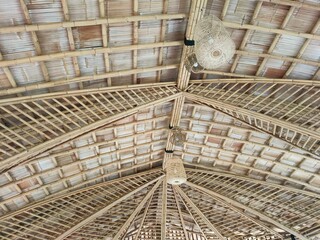 The lamp and the roof are made of bamboo.