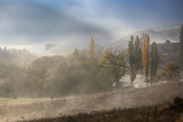Fototapeta na wymiar Beautiful landscape in a foggy autumn morning in the Crimean village